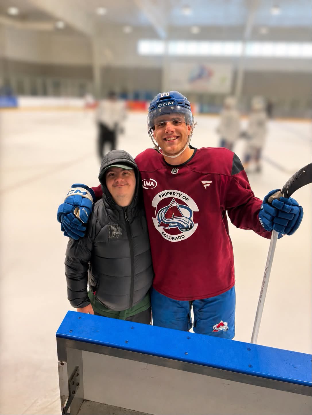 Tyler sharing a rinkside moment with a Colorado Avalanche player